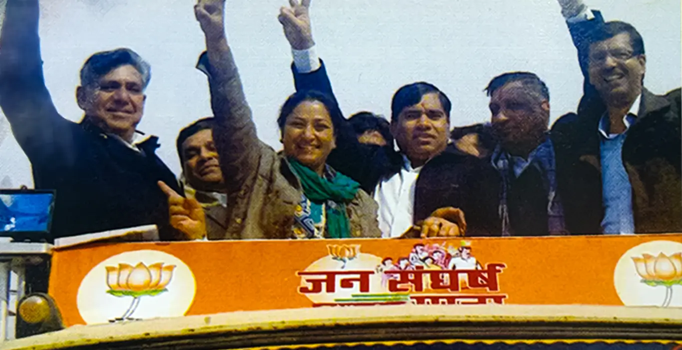 Rekha Gupta waving alongside fellow leaders at a BJP rally