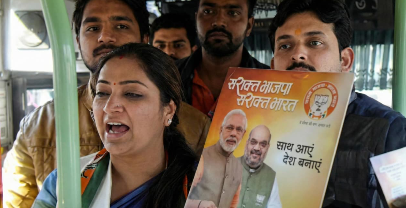 Rekha Gupta participating in a BJP outreach activity with a party membership poster
