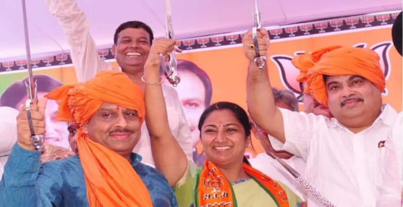 Rekha Gupta raising a ceremonial sword alongside fellow leaders on stage