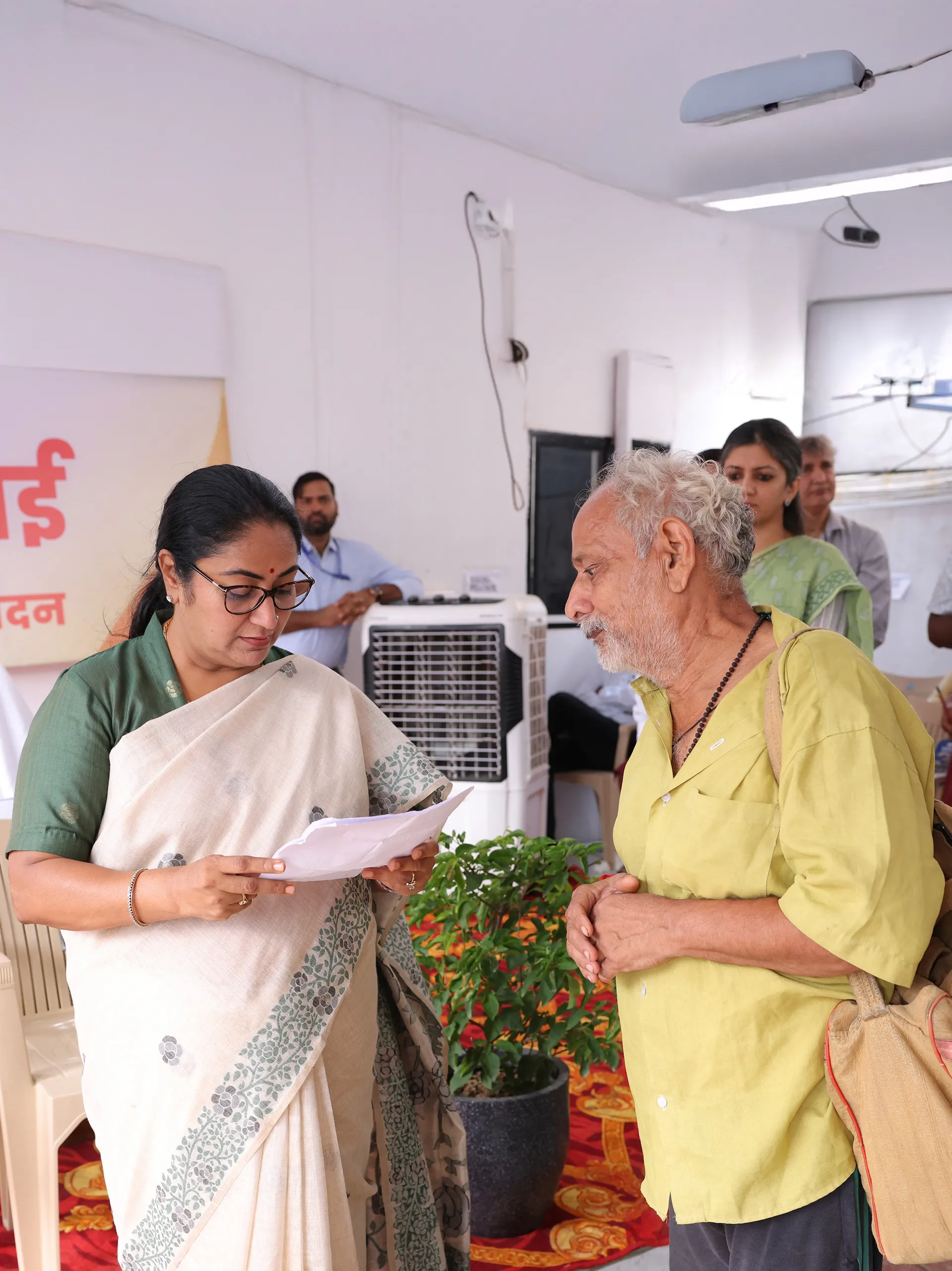 Delhi CM Rekha Gupta reviewing documents with a citizen at Jan Seva Sadan