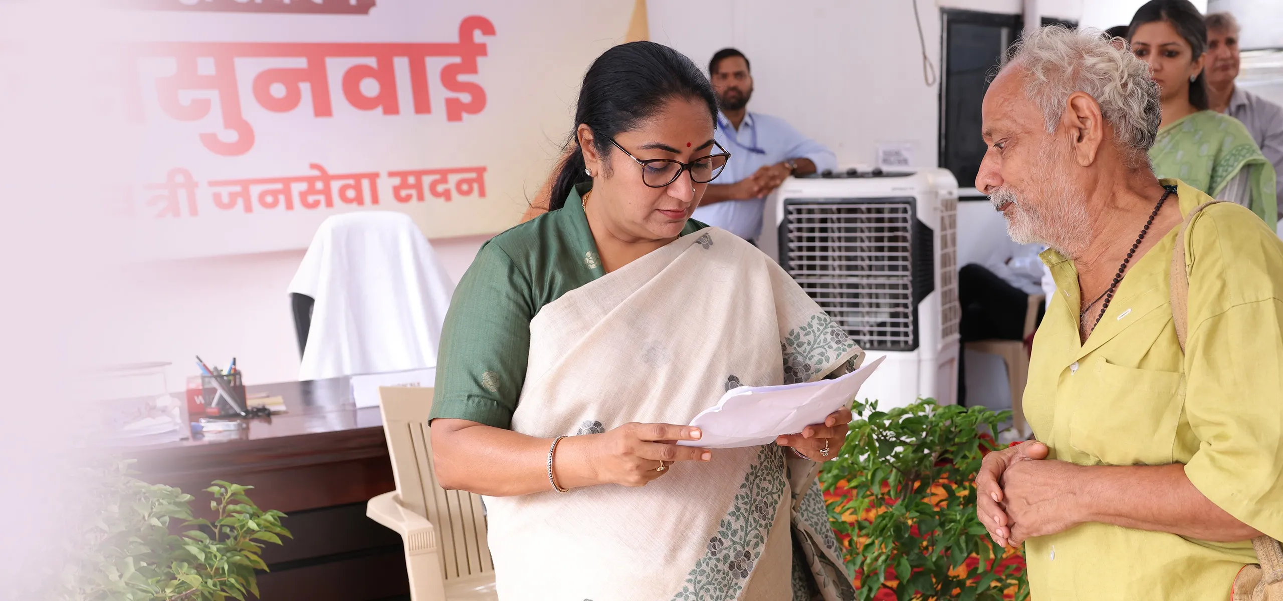 Delhi CM Rekha Gupta reviewing documents with a citizen at Jan Seva Sadan